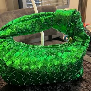 A NEW green metallic purse